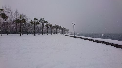 Scenic view of snow covered land against sky