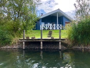 House by lake against building