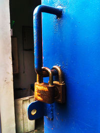 Close-up of padlock on blue door