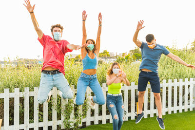 Group of people jumping outdoors