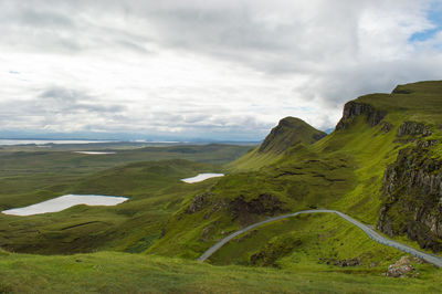 Scenic view of green landscape against sky