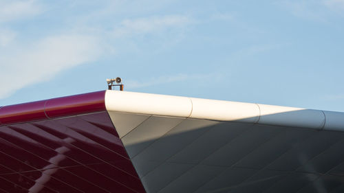 Low angle view of coloured roof against sky