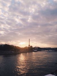 View of river against cloudy sky at sunset