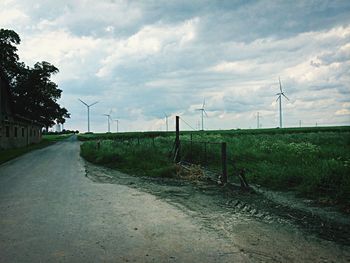 Empty road against cloudy sky