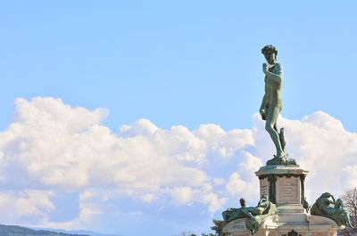 Low angle view of statue against blue sky