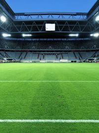 View of illuminated soccer field at dusk