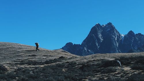 Scenic view of mountains against clear blue sky