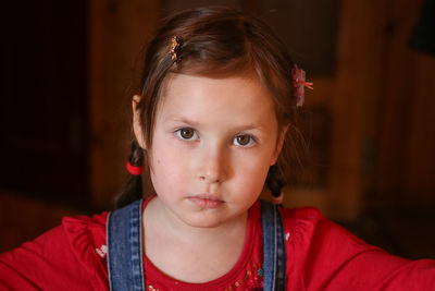 Portrait of young girl with expressive eyes and pure innocence, with serious expression on her face
