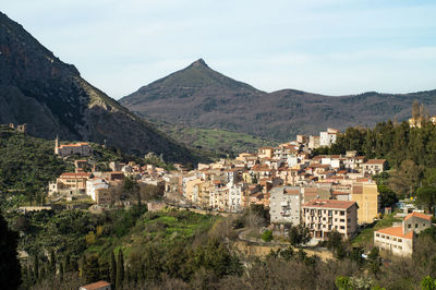 Townscape by mountain against sky