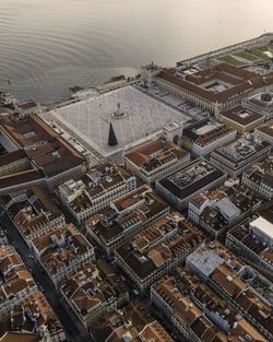 High angle view of townscape by sea against sky