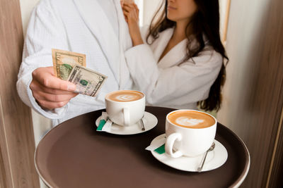 Room service serving coffee to customer