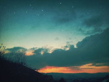 Low angle view of landscape against sky at night