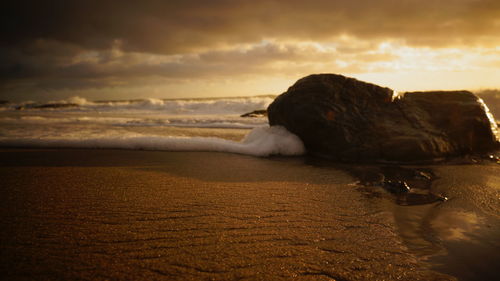 Scenic view of beach against sky during sunset