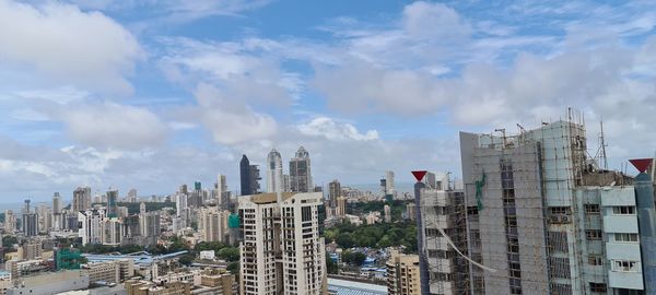 Panoramic view of buildings in city against sky