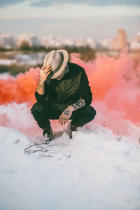 Young woman in hat against sky