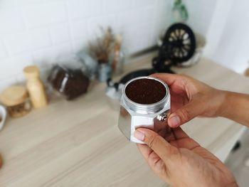 Midsection of woman holding coffee cup