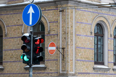 Pedestrian traffic light with a timer on the background of the building, closeup