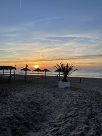 Scenic view of beach against sky during sunset