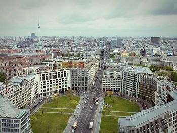 View of cityscape against cloudy sky