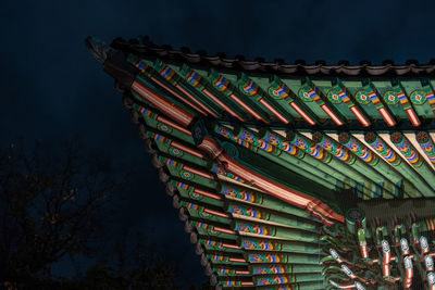 Low angle view of illuminated building against sky at night