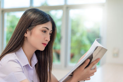 Portrait of young woman using mobile phone