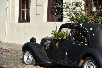 Old car parked outside building