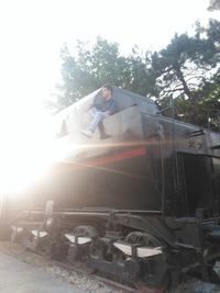 Man standing by train on railroad track