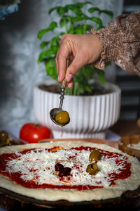 Cropped hand of person preparing food