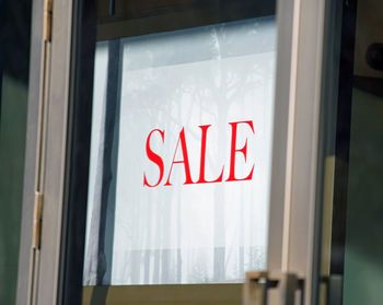 Sign with painted lettering of the sale in the storefront