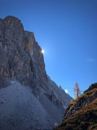 Scenic view of rocky mountains against clear blue sky