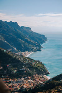 High angle view of townscape by sea against sky