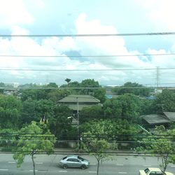 Car on road against cloudy sky