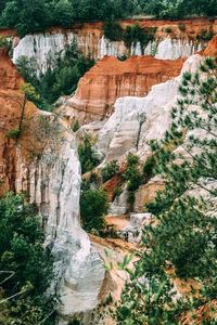 Rock formation and trees against sky