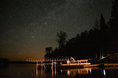 Scenic view of lake against sky at night