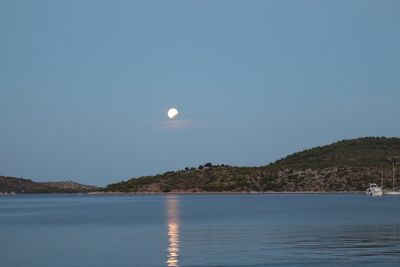 Scenic view of sea against clear sky at night