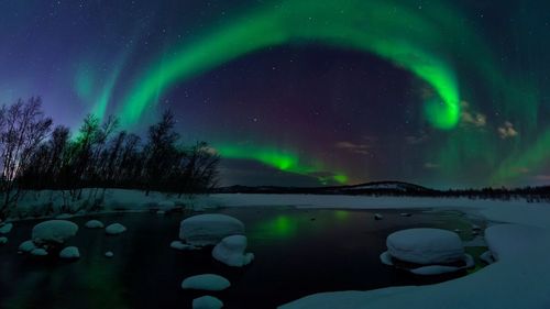 Scenic view of landscape against sky at night