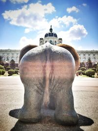 Statue of historic building against cloudy sky