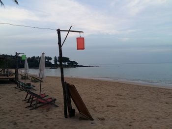 Lifeguard hut on beach against sky