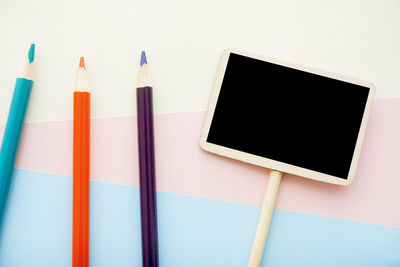 Close-up of multi colored pencils against white background