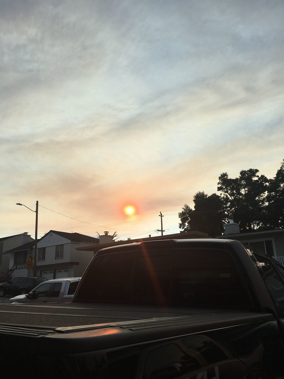 car, mode of transportation, motor vehicle, sky, sunset, transportation, land vehicle, cloud - sky, tree, architecture, nature, plant, building exterior, orange color, built structure, sun, sunlight, no people, outdoors, road, lens flare, road trip