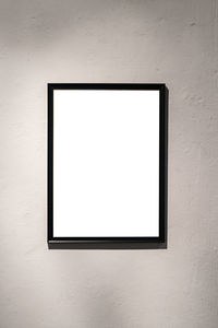 Blank white frame on wall