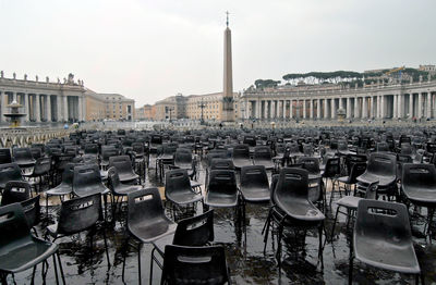 Empty wet chairs at st peter basilica