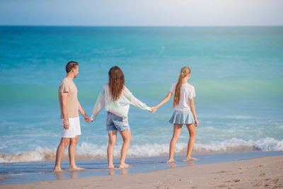 Friends standing at beach