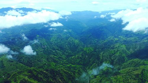 Aerial view of green mountains during foggy weather