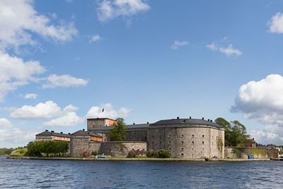 Vaxholm fortress by sea against sky