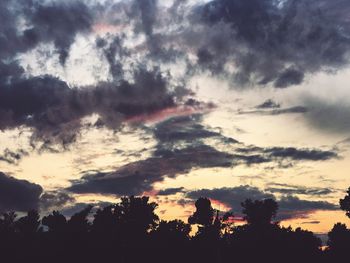 Low angle view of silhouette trees against sky during sunset