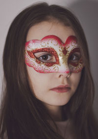 Portrait of a girl in a carnival mask.