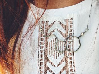 Close-up of woman against white wall