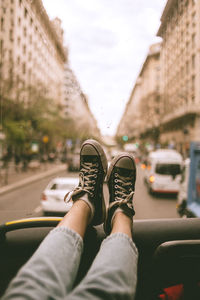 Low section of woman in vehicle against buildings