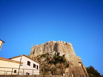 Low angle view of fort against blue sky